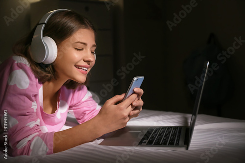 Teenage girl with laptop an...