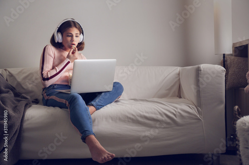 Teenage girl with laptop ea...