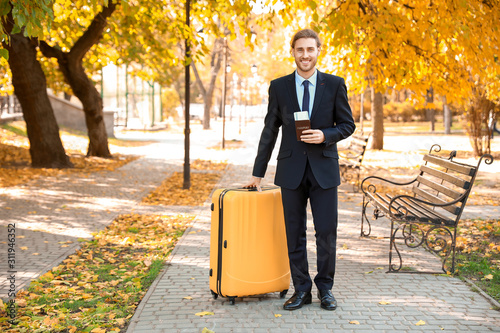 Young businessman with lugg...