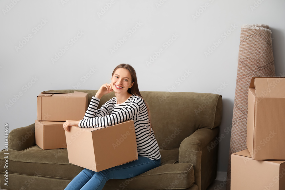 Happy young woman with moving boxes in new house Happy young woman with moving boxes in new house