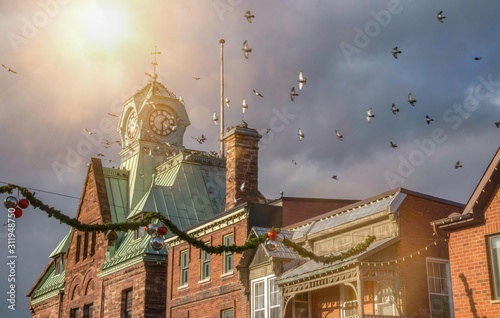 Almonte post office clocktower with birds flocking and sun flare nobody photo