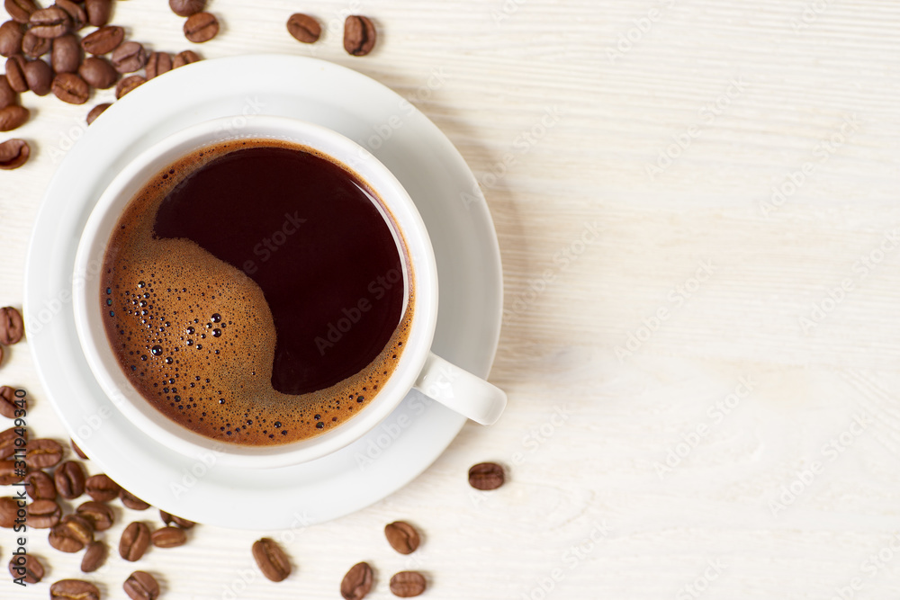 Fototapeta premium Americano and coffee beans on white wooden table