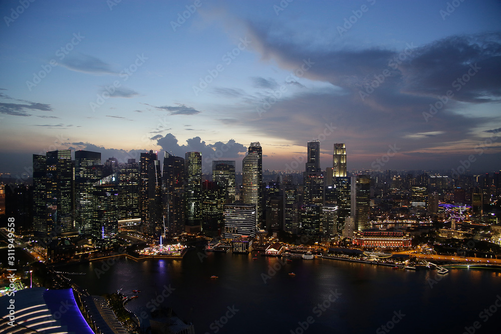 Evening aerial view of skyscrapers in Singapore downtown under cloudy sky. Modern architecture. Contemporary business city with high-rise buildings. 