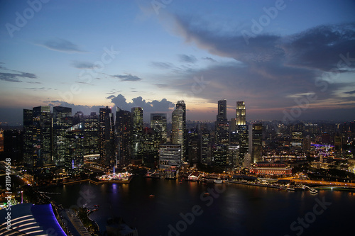 Evening aerial view of skyscrapers in Singapore downtown under cloudy sky. Modern architecture. Contemporary business city with high-rise buildings.  © nonpareil