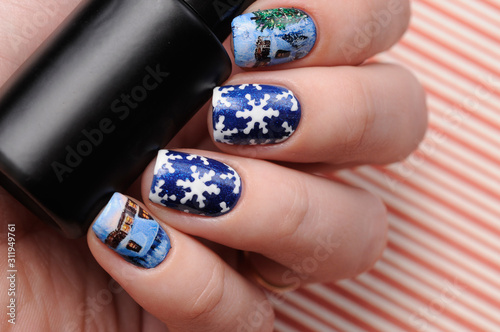 Winter blue manicure with shimmer and snowflakes pattern on red lines candy background