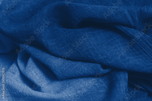 Navy classic blue fabric texture background top view. Crumpled Cloth Blank Background. Colour of the year 2020. Trendy Classic Blue color. Fabric natural surface background. Selective focus.