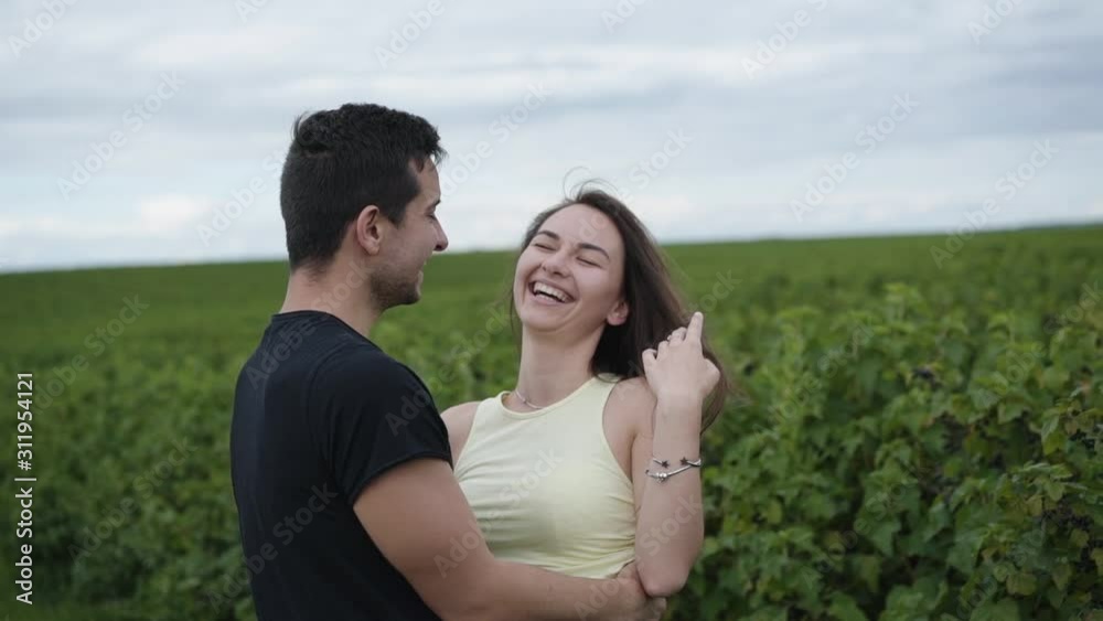 Happy couple rejoicing in the embraces among green plantation Happy couple rejoicing in the embraces among green plantation