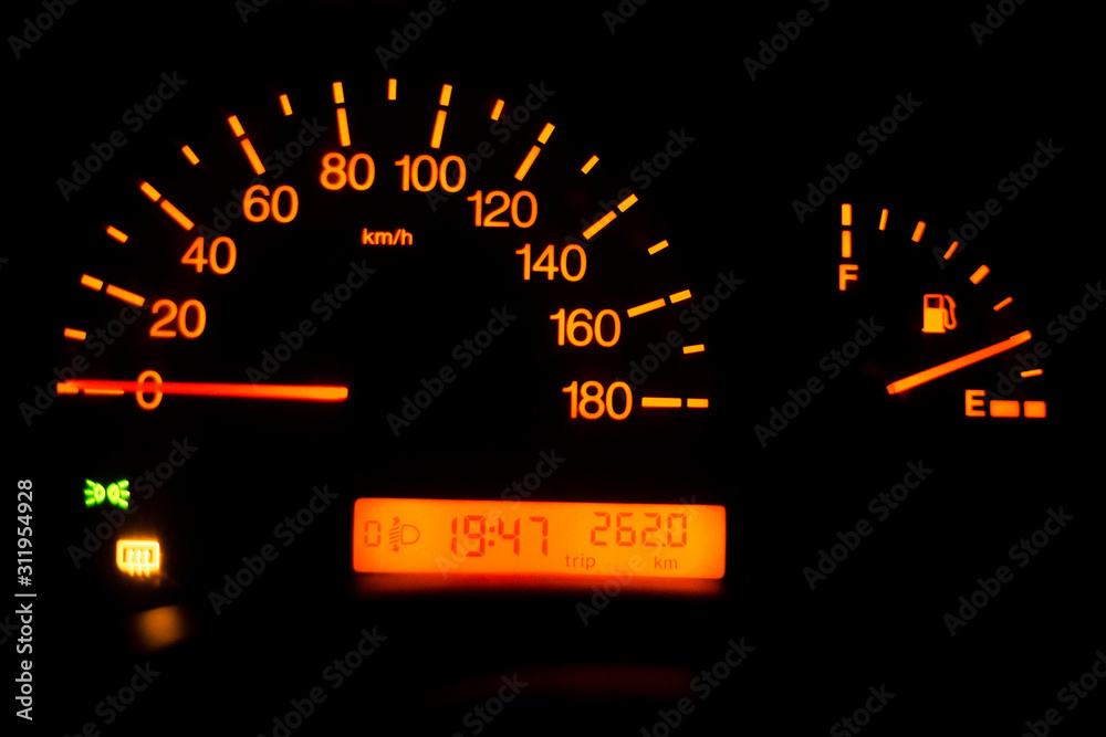Close-up of a speedometer and fuel gauge in a car at night Close-up of a speedometer and fuel gauge in a car at night