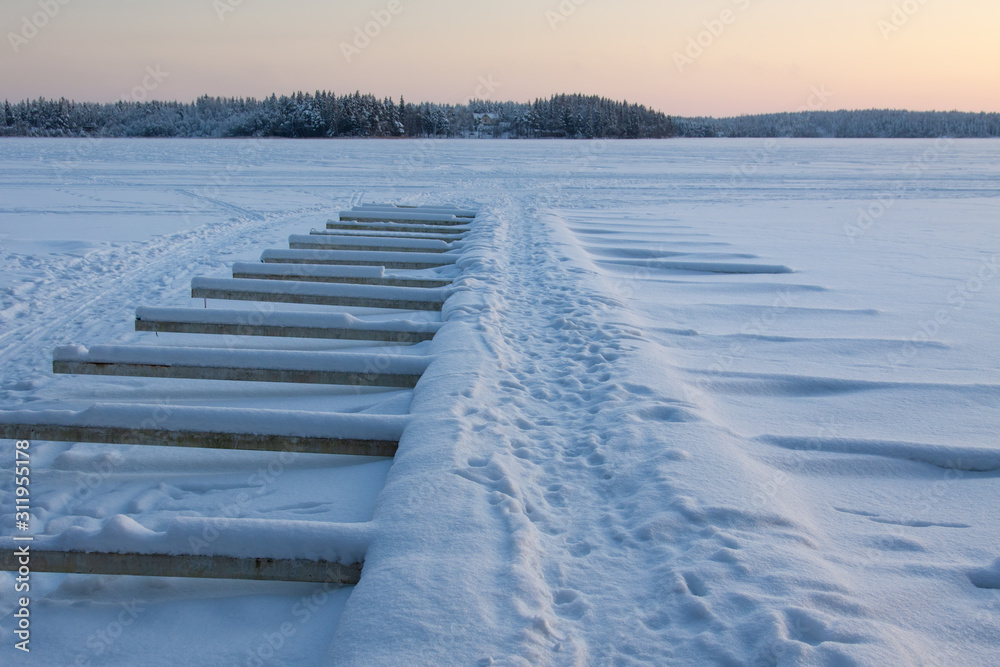 Wonderful winter landscape with snow covered wooden pier, Finland. Wonderful winter landscape with snow covered wooden pier, Finland.