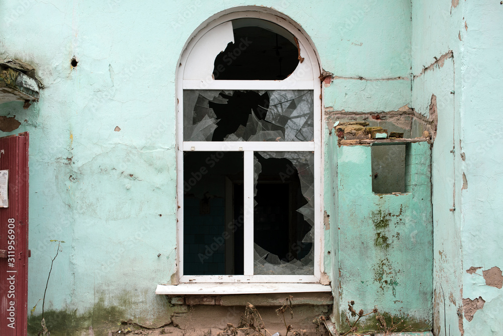 Broken window in an old residential building.