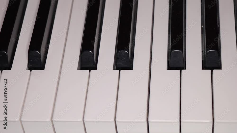 Slow pan along piano keys from straight above, close-up Slow pan along piano keys from straight above, close-up