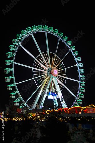 Colorful illuminated big wheel at the Christmas market in Berlin, Germany.
