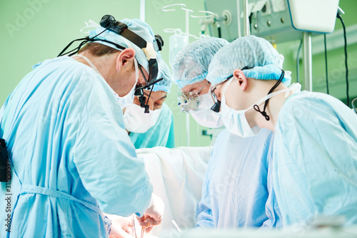 male cardiac surgeon at child cardiosurgery operating room photo