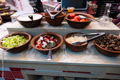 Colourful salads served on table of self service cafe