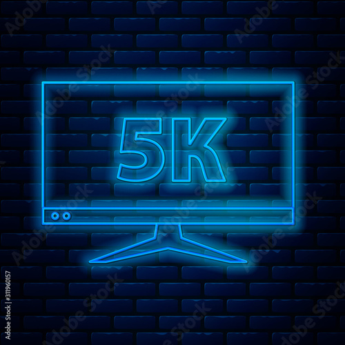 Glowing neon line Computer PC monitor display with 5k video technology icon isolated on brick wall background. Vector Illustration