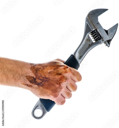 Dirty and oily hand holding adjustable wrench tool isolated photo