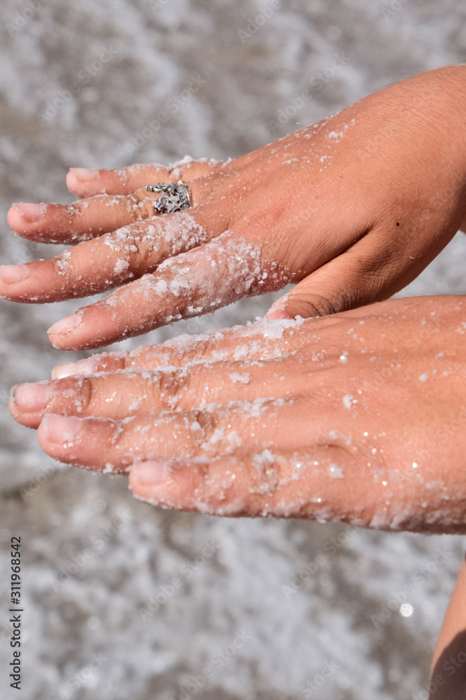 Fototapeta premium Salt on the girl's hands