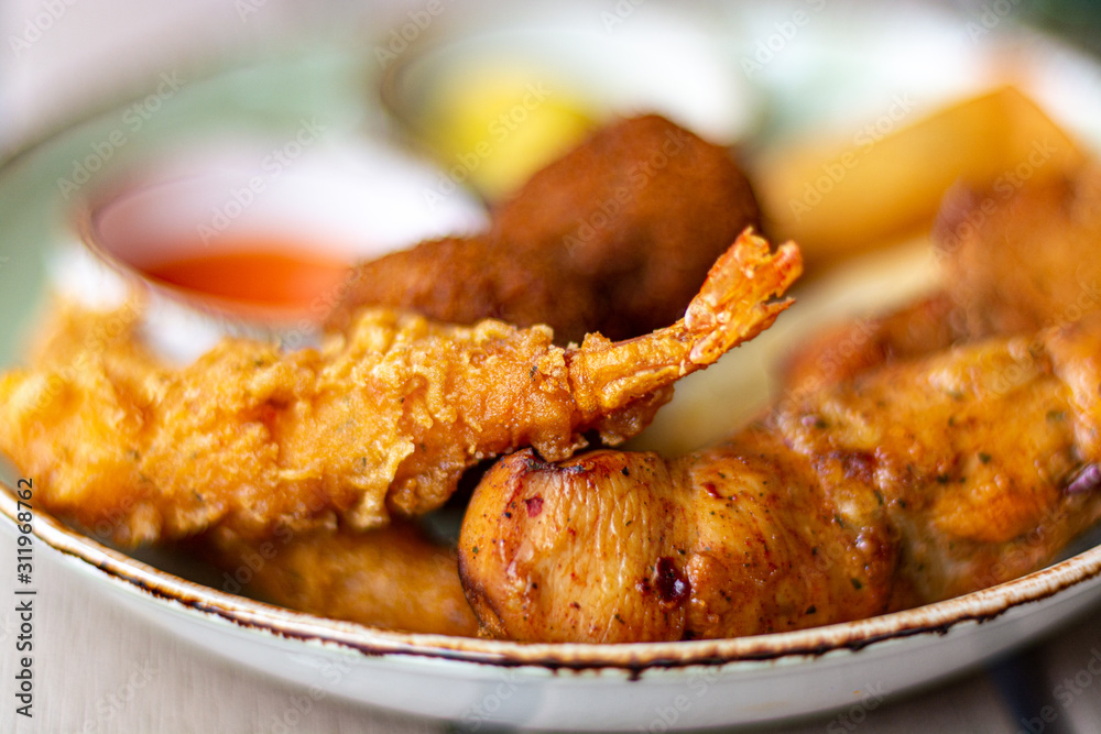 Dutch snacks for beer or wine, tempura shrimps, skewered chicken, bitterballs and hot dip sauces Dutch snacks for beer or wine, tempura shrimps, skewered chicken, bitterballs and hot dip sauces