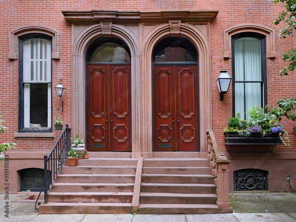 Brownstone style apartments with elegant double wooden mahogany front doors Brownstone style apartments with elegant double wooden mahogany front doors