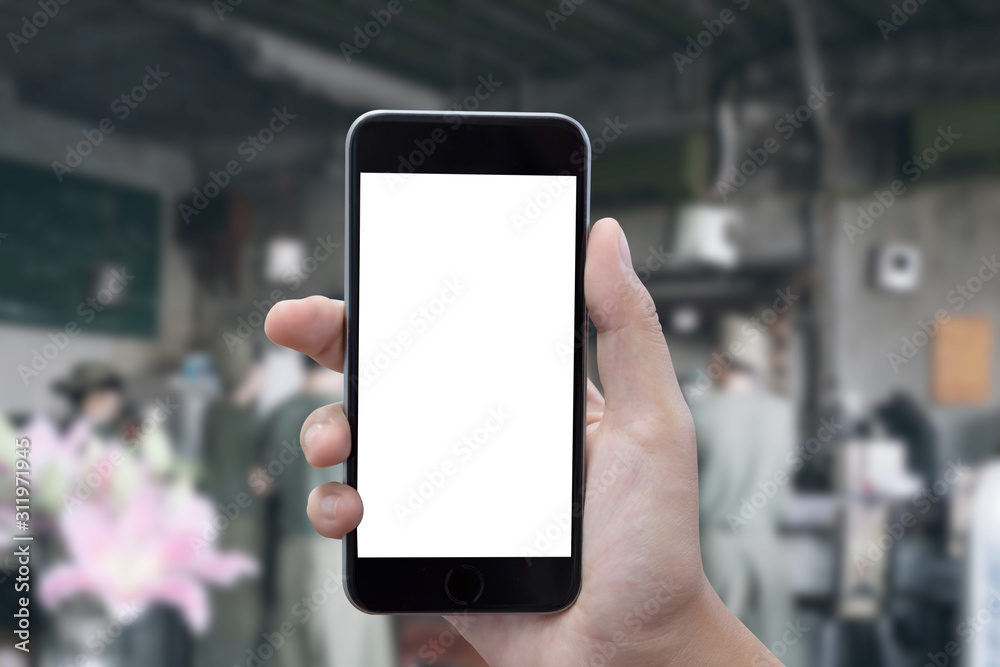 close up of man hands with smartphone texting message on city street blurred background. blank screen for graphics display montage.
