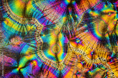 Extreme macro photograph of Vitamin C crystals forming abstract modern art patterns under polarized light photo