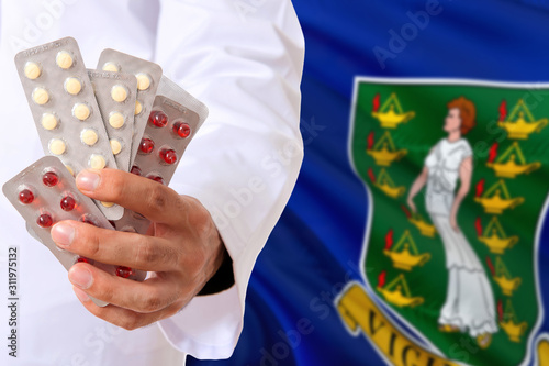 British Virgin Islands pharmacy and medicine concept. Doctor holding pills tablet on national flag background. Health theme with copy space for text.