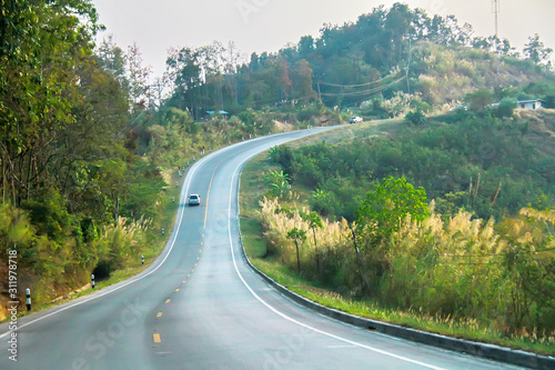 sunset on curve road in the mountain and forest  country road of Nan in north of Thailand