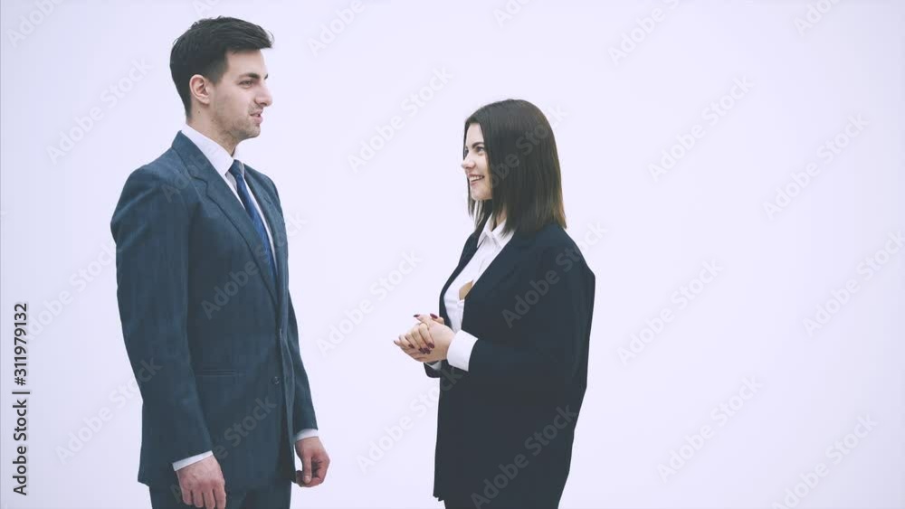 Negotiation of business partners. Man and woman in suits talking desparately, using gestures, shaking their hands. Negotiation of business partners. Man and woman in suits talking desparately, using gestures, shaking their hands.
