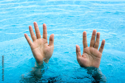 The man's hand drowned, he lifted his hand and asked for help from drowning at the sea.