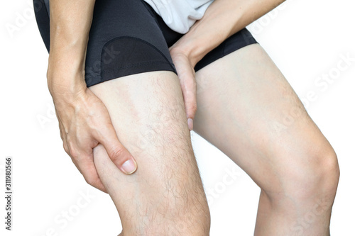 Leg muscle pain.young man and grasped his muscles. With foot pain and stretching, fatigue muscles to alleviate pain, health concepts.