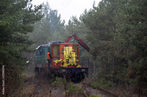 Special railway service train cuts overhanging branches. Near Kiev  Ukraine