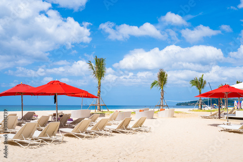 red beach umbrella and beach chair on the beach