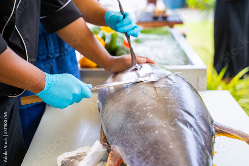 chef split big tuna with knife photo