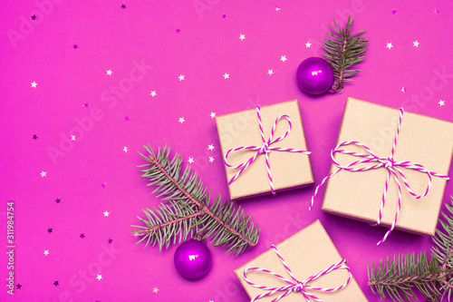 Christmas composition with gifts, branches and holiday elements on the violet background. Flat lay. Merry Christmas, New Year, winter concept.