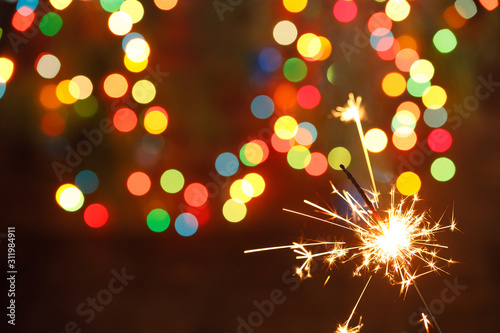 Canvas Print beautiful sparklers on the background of a garland
