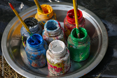 Tableau sur toile Used poster color bottles with brush for painting shot in selective focus