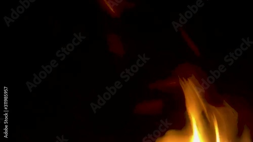 A smooth steady slow motion shot of fire wafting into frame from below, growing and flickering from the rush of heat. photo