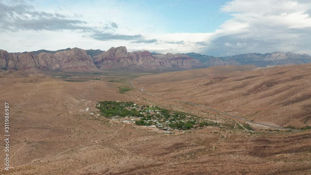 Aerial pull back view of Blue Diamond with Red Rock Canyon peaks in background Aerial pull back view of Blue Diamond with Red Rock Canyon peaks in background