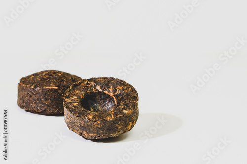 Fermented Chinese Pu'er tea on a white background macro close-up.