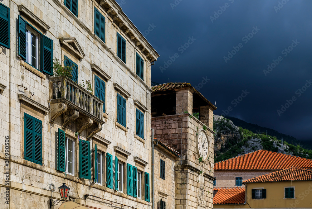 Picturesque brick walls of houses and City Tower in the Old town of Kotor Montenegro in the Balkans on the Adriatic Sea