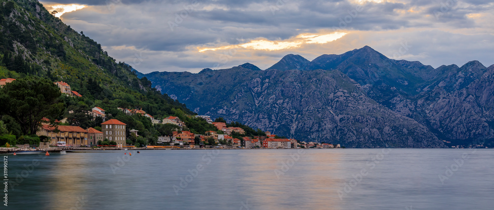 Panorama of Kotor Bay or Boka Kotorska with mountains, clear water at sunset, the Balkans Montenegro on the Adriatic Sea