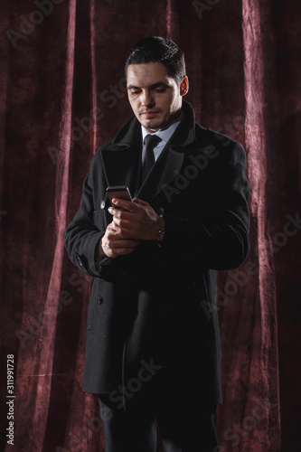 Handsome man in a business suit on a dark background