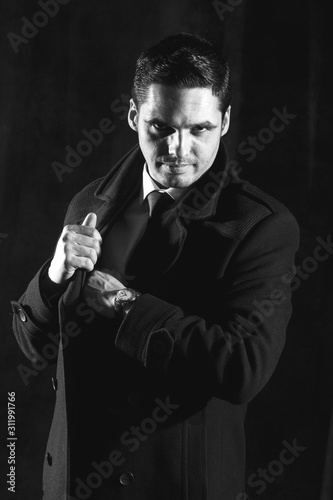 Handsome man in a business suit on a dark background