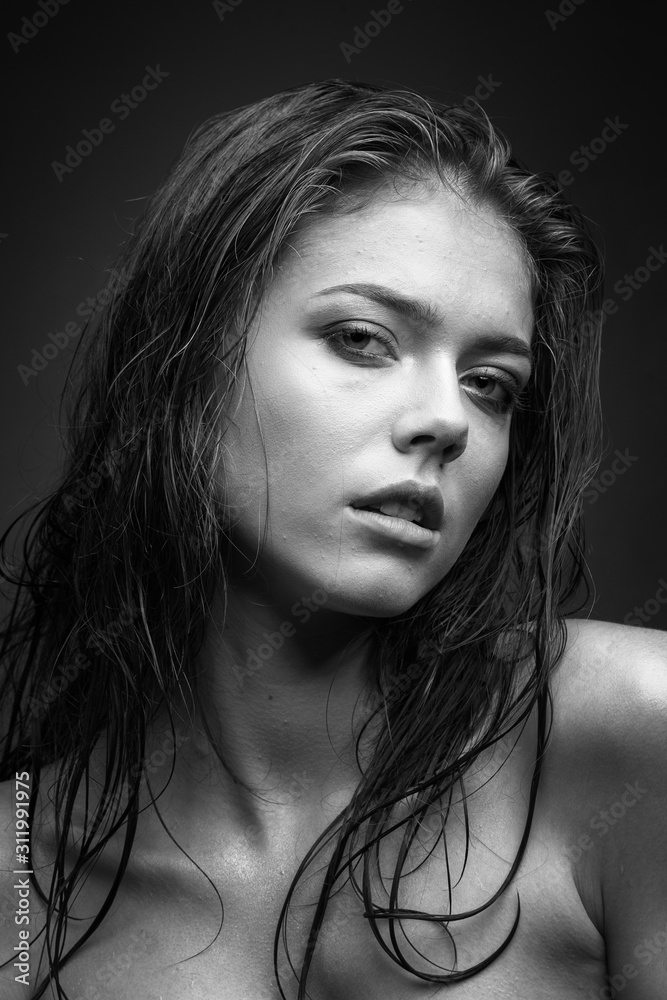Expressive black white portrait of a young attractive girl with wet dark hair Expressive black white portrait of a young attractive girl with wet dark hair
