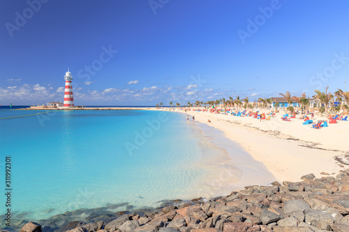 Tropical beach with lightouse on an Bahamas island photo