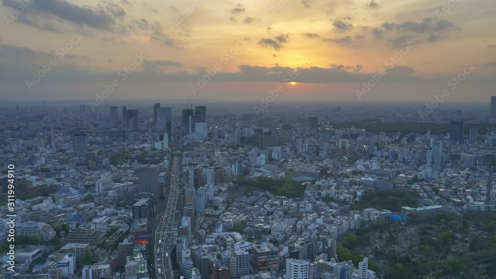 route 3 shuto expressway from mori tower as sun sinks beneath clouds in tokyo