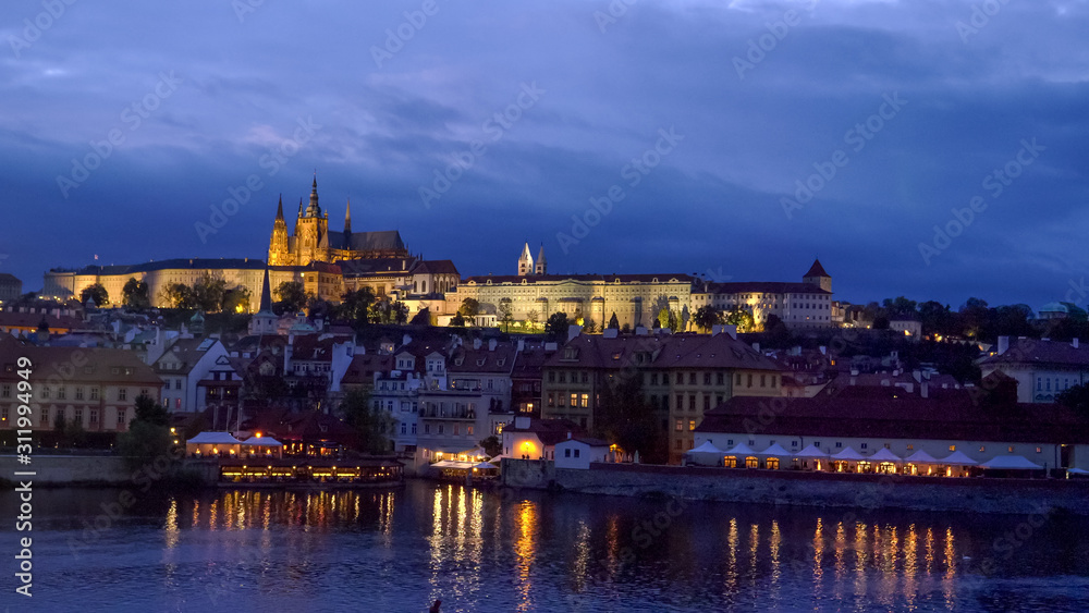 night shot of prague castle and the vltava river in prague