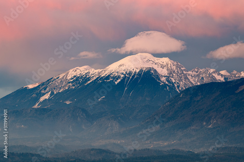 Mountain peeks of Karavanke range Alps just before the sunset, with the afterglow lit sky viewed from Kranj, Slovenia
