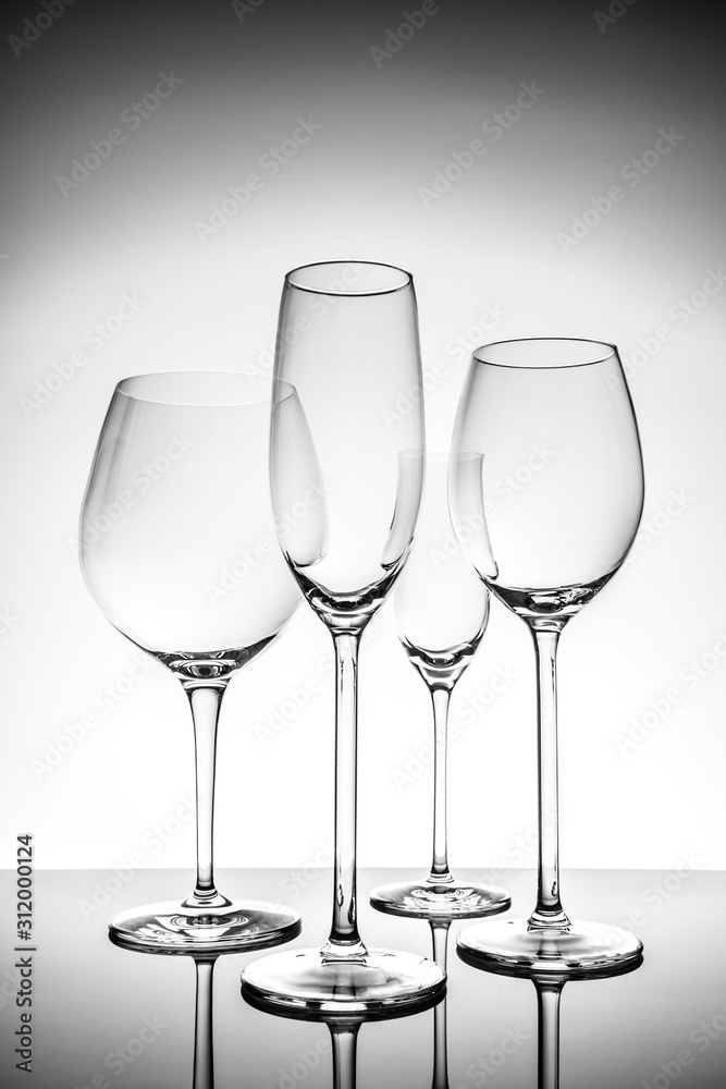 Glassware selection with wine, champagne and liquour glasses on the light background.. Fine cristal glassware concept. Vertical Glassware selection with wine, champagne and liquour glasses on the light background.. Fine cristal glassware concept. Vertical