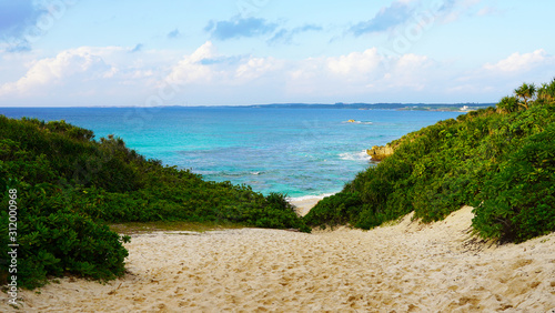 Japan's famous tropical beach. Sunayama beach wild beautiful beach with golden sand and clear blue water of the Pacific Ocean. road throw jungle photo